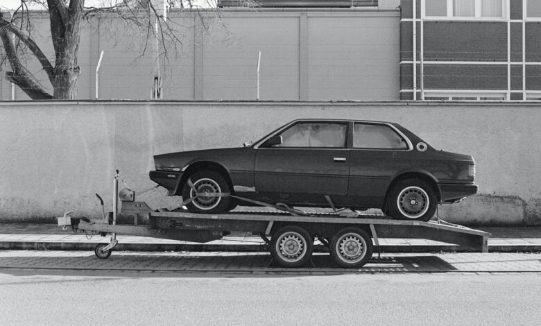 a car is being towed on a flatbed trailer